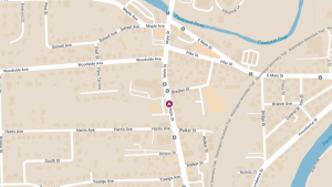 Motorcyclist Hospitalized After Colliding with Parked Vehicle on Main Street